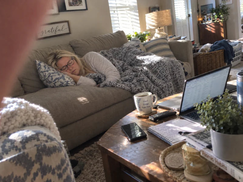 Mujer durmiendo la siesta en un sofá durante la tarde